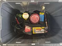 Photo of the lot contents including soldering iron, poly rope, screwdriver bits, and tape in a plastic bin