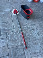 Full view of the O-Cedar mop with microfiber triangular mop head and handle next to the mop scrubber bucket.