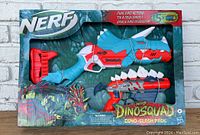 Front view of the boxed Nerf Dinosquad Dino-Clash Pack showing two dinosaur-themed blasters inside packaging.