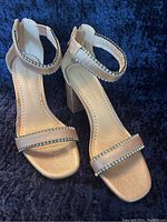 Front and side view of the blush pink heeled sandals with rhinestone embellishments on ankle and toe straps.