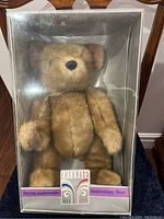 Photo of Eaton 125th Anniversary Bear inside original box, showing bear standing facing front.
