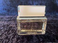 Front view of the Givenchy Dahlia Noir Eau de Toilette bottle showing the brand name and transparent glass bottle with liquid inside.