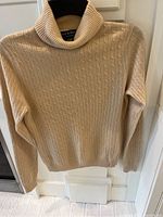 Front view of beige Grayson & Dunn cashmere turtleneck sweater on mannequin.