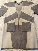 Front view showing striped grey and white pattern and two front pockets.