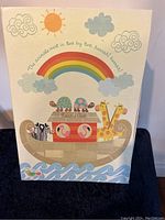 Front of the box featuring a colorful illustrated Noah's Ark with animals and rainbow motif.