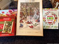 Image showing four puzzles including a 1000-piece winter sledding scene by Trefl in the center, a Coca-Cola Christmas puzzle on the left, a 300-piece floral puzzle behind Coca-Cola, and a Merry Xmas edition puzzle on the right.