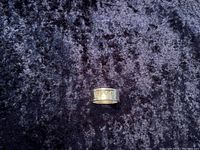 Top view of wide silver band showing engraved Gucci logo