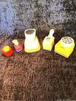 Front view of five various crafting paper punches showing different sizes and punch designs (mountain, butterfly, keyhole, floral)