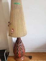 Full view of lamp showing tall conical shade and ceramic base