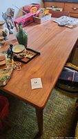 Full top view of table with miscellaneous items showing surface and corner.