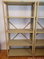 Front view of entire metal shelving unit showing all five shelves and frame.