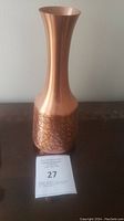 Full view of vintage copper vase with crackled pattern and flared lip, sitting on a surface with a lot number card.