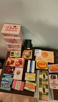 Overview photo showing an assortment of vintage soap bars including multiple Dove bars, Coast, Kamille, Krauter, and Lico brands, arranged on a flat surface.