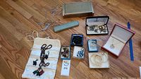Full layout of costume jewelry pieces including necklace with elephant pendants and multiple jewelry boxes.