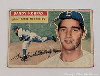Front side of the 1956 Topps Sandy Koufax Brooklyn Dodgers baseball card showing pitching action photo, portrait, and facsimile signature. Card is worn with some creases and discoloration.