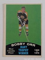 Front of the vintage 1970-71 OPC Bobby Orr hockey card showing him in Boston Bruins uniform with text about his Hart Trophy wins.