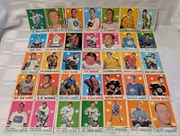 Photo of 35 different 1970-71 OPC hockey cards displayed laid out flat showing player images and team names.