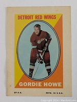 Front view of the Gordie Howe decal sticker showing the full image with vibrant yellow and orange background, depicting Gordie Howe in his Detroit Red Wings uniform.