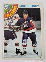 Front side of the 1978-79 O-Pee-Chee Mike Bossy rookie card showing Bossy in action wearing New York Islanders uniform.