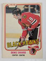 Front of 1981-82 O-Pee-Chee Denis Savard rookie hockey card featuring player in Chicago Black Hawks red uniform with number 18.