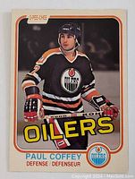 Front of 1981-82 O-Pee-Chee Paul Coffey rookie card showing player in Edmonton Oilers jersey with 'OILERS' text, name and position below.