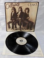 Vinyl LP record with label centered on white inner sleeve, showing glossy black vinyl grooves