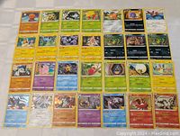 Front side of 50 Pokemon trading cards displayed in a grid showing various Pokemon characters and types in vintage style.