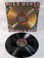 Photo of the vinyl record LP outside the sleeve, showing black vinyl disc with label detailing songs and production info.