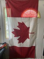Canadian flag hanging in front of window
