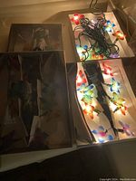 Four boxes displayed with butterfly string lights inside, showing multi-colored butterfly light covers and wiring.