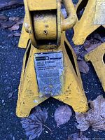 Close-up of one yellow Wilmar jack stand label showing 6000 lbs capacity and serial number.