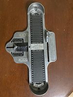 Top view of the Brannick foot measurement device showing length scales for right and left heel to toe length, and sliding width gauges for left and right foot width with measurement markings and brand labeling.