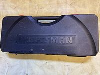 Closed black hard plastic carrying case with the 'Craftsman' logo embossed on the top.