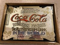 Vintage Coca-Cola mirror beer sign measuring approximately 12 x 16 inches with gold and red lettering