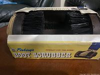 Close-up of Fiebing's Boot Scrubber with visible bristles and packaging.