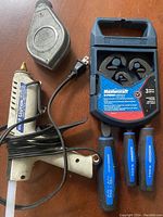 Photo showing the entire kit arrangement including Mastercraft express wrench in blue plastic case, three blue-handled wrenches, white glue gun, and metal chalk line tool
