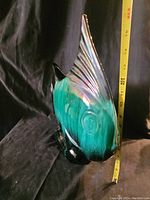 Side angle view of the fish vase showing height with measuring tape