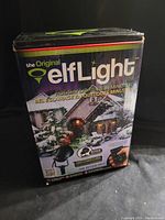 Front view of box showing branding, 'the Original elfLight' and that it is a holiday lighting product with quick setup.