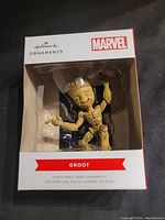 Front view of the Hallmark Marvel Groot ornament in its original box showing full figure of Groot and branding.