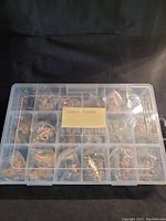 Closed plastic organizer box with multiple bagged small figurines inside labeled 'Nursery Rhymes'