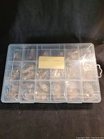 Compartment box with multiple small individually bagged wooden figurines inside, labeled "Nursery Rhymes".