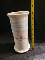 Full view of vase with measuring tape showing height at about 8 inches