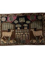 Full front view of the Ardebil wool rug showing village motifs with cattle, houses, and trees framed by a decorative border.