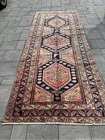 Full length view of runner rug laid flat on stone floor