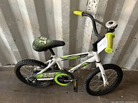 Full side view of a white Movelo children's bike with 16-inch wheels, showing the frame, seat, handlebars, and pedals.