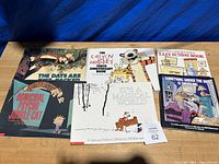 Photo of six Calvin & Hobbes books laid out on a surface, showing the front covers.