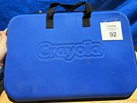 Blue zipper carrying case with Crayola embossed on front and black handles
