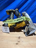 Side view of DeWalt impact driver and circular saw with taped note stating 'Test works no battery'