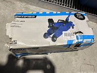 Damaged box with branding and product photo of the trolley jack