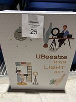 Photo of the original UBeesize Ring Light Set packaging box with illustrative graphics showing ring light on tripod.